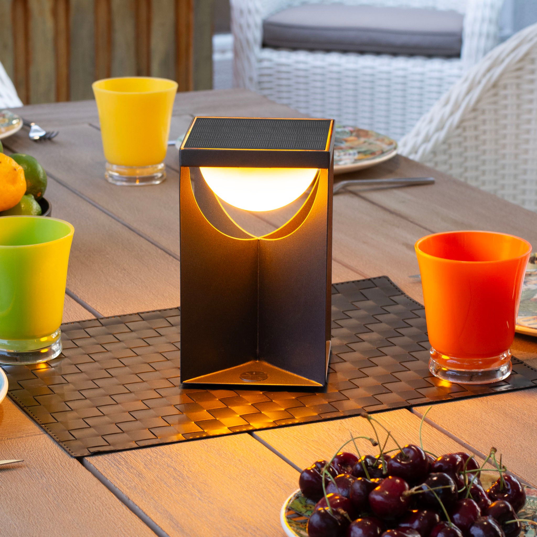 Flow table lamp in amber light mode on outdoor dining table