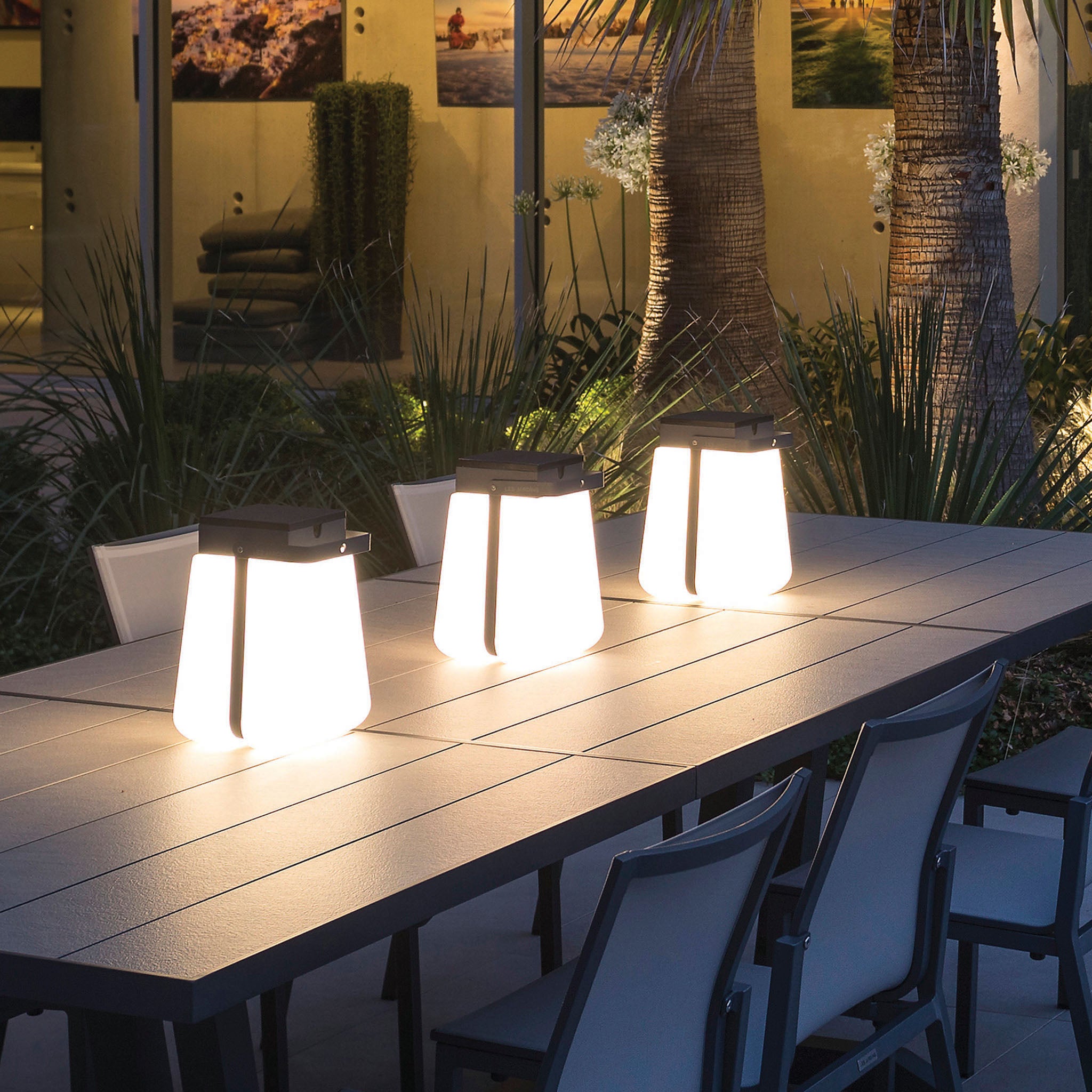 bump solar lantern lighting up outdoor dining table and garden