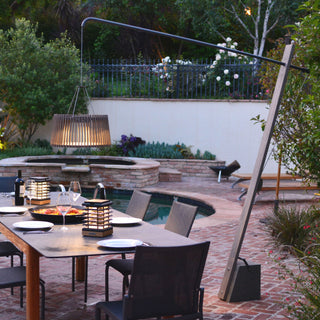 pendulum floor lamp lighting up outdoor dinning and pool