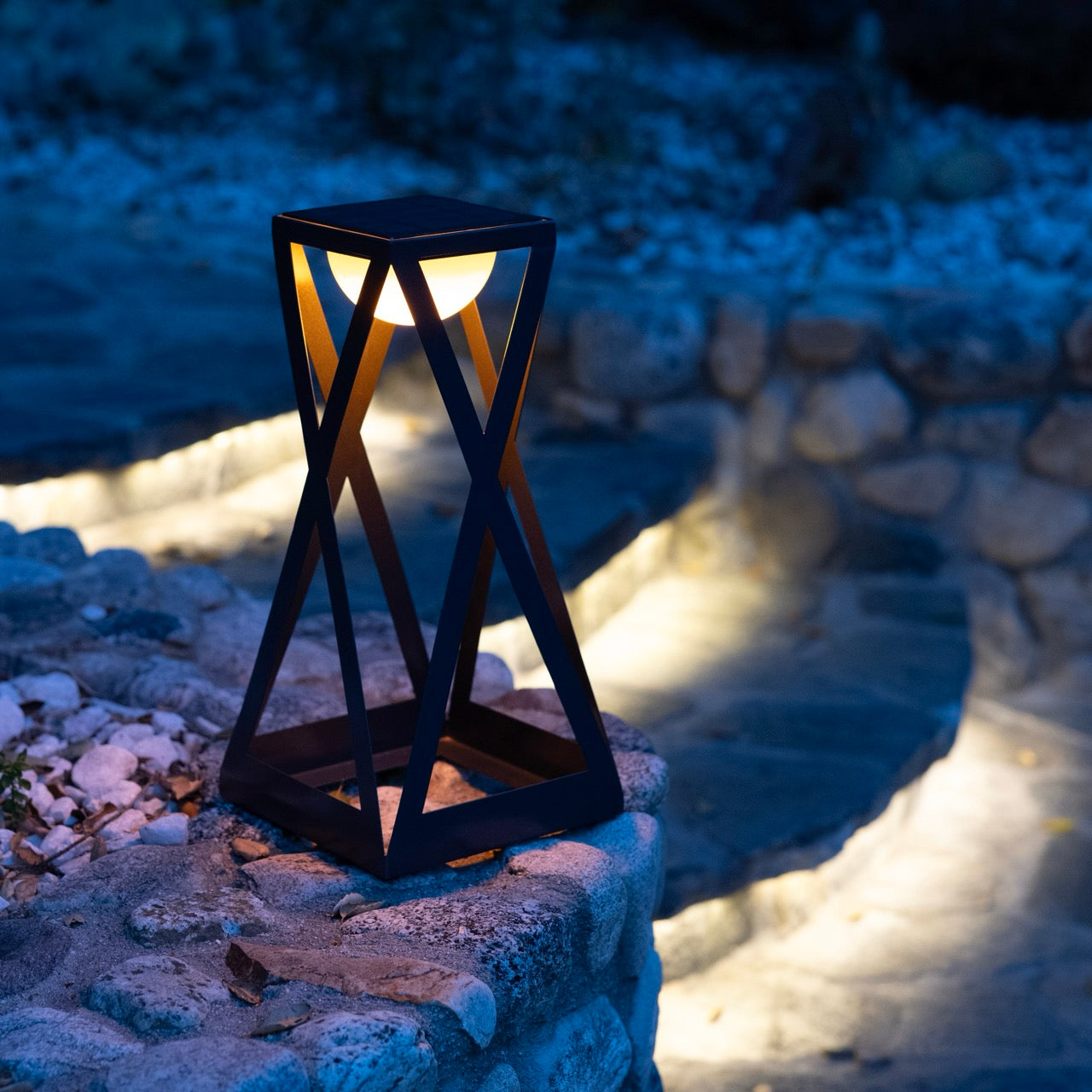 Rick solar lantern with ykary bulb white light outdoor on rock and steps