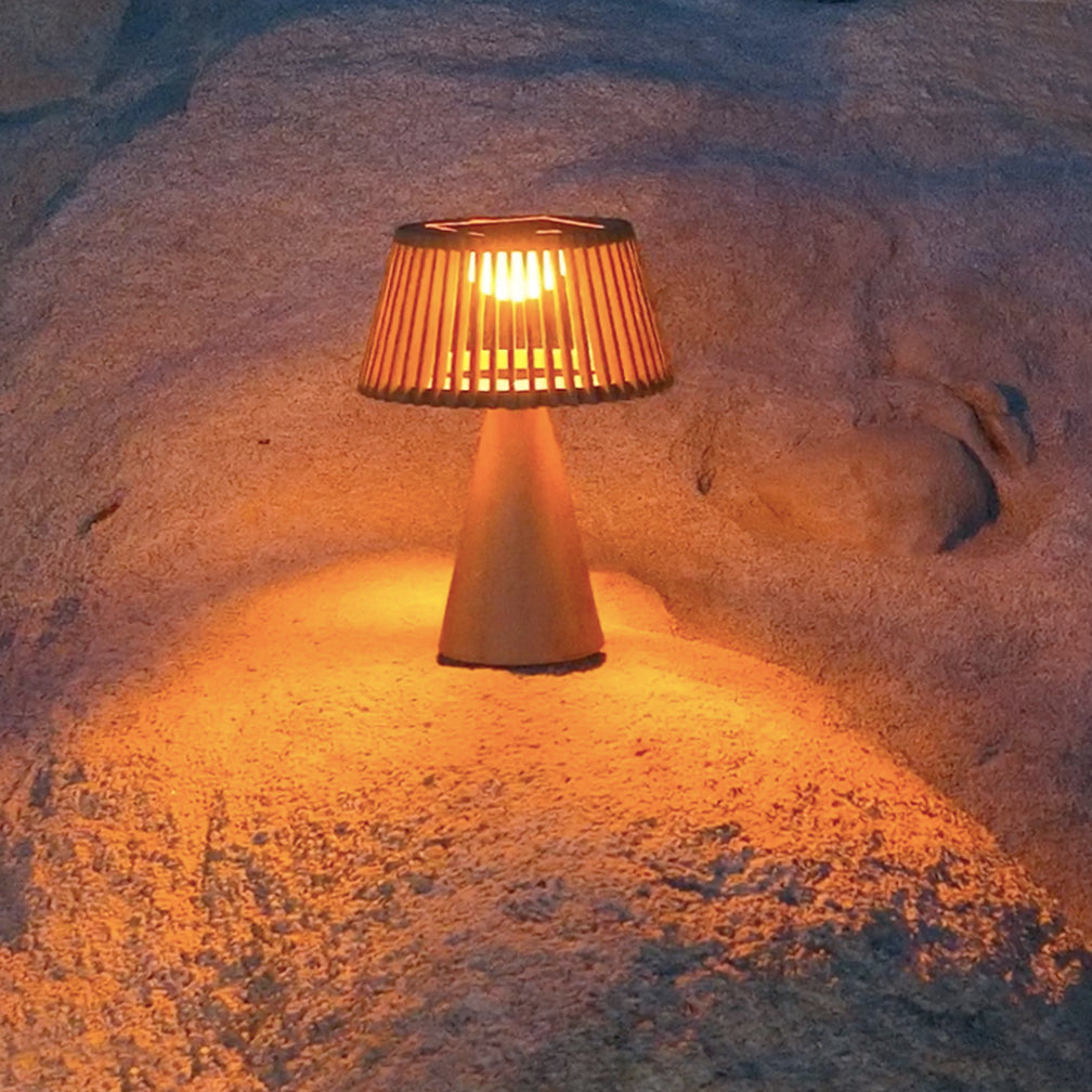 enoki solar lamp lighting up on a rock outdoor
