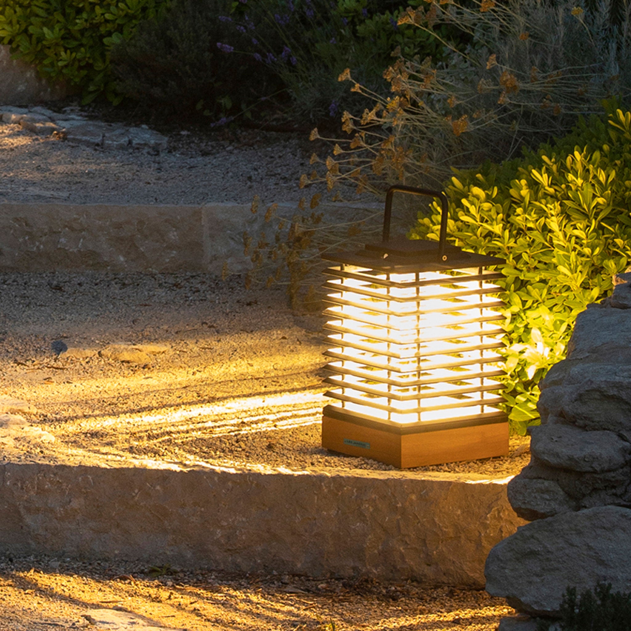 High efficiency tekura lantern in small, teak lighting up pathway